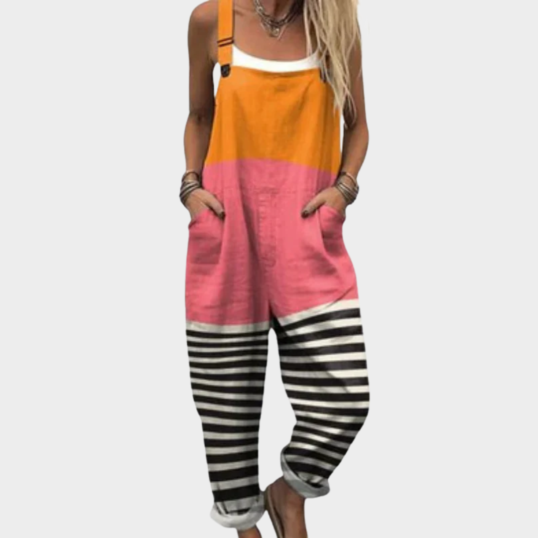 Woman wearing colour-block dungarees in orange and pink with black-and-white striped legs