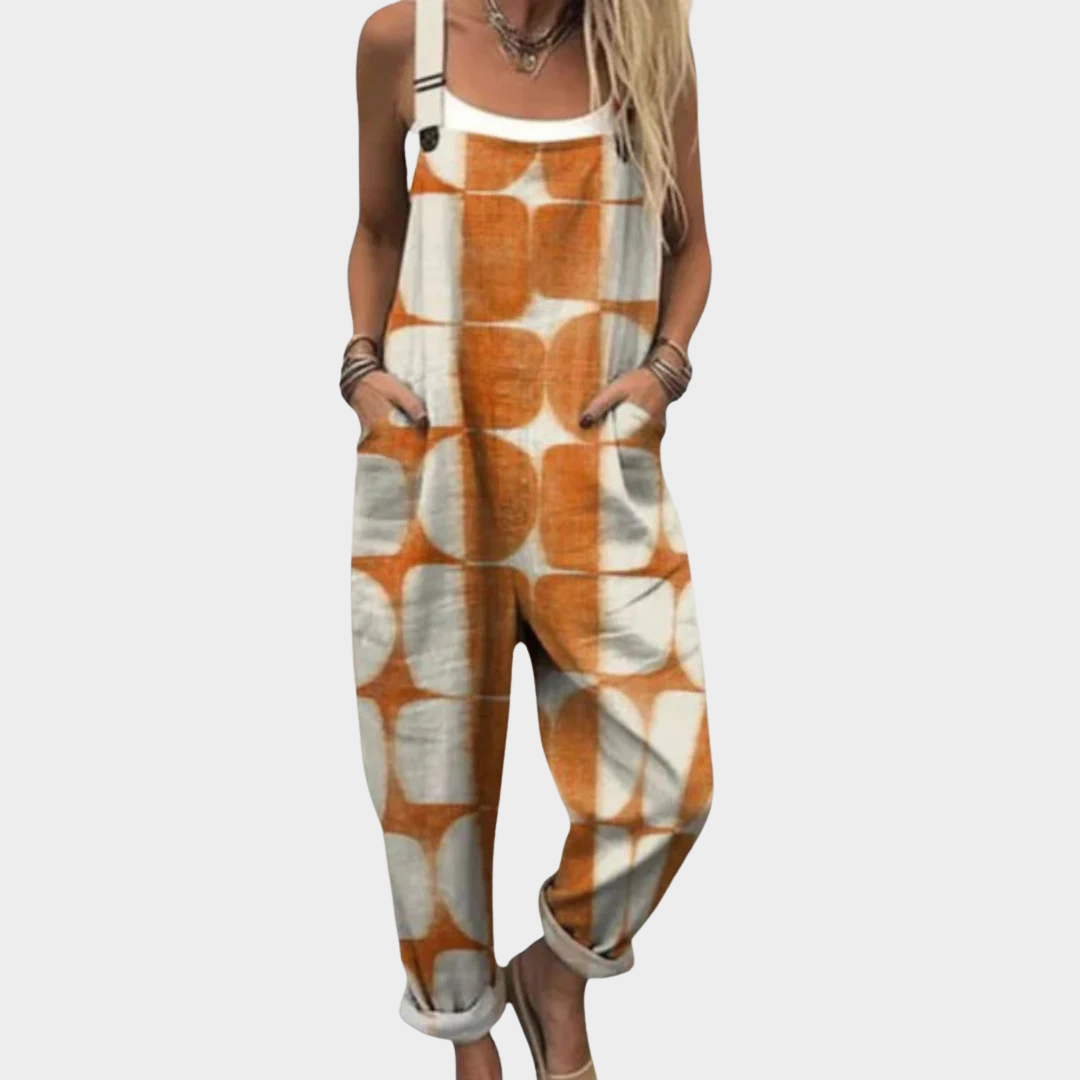 Woman wearing cream dungarees with warm orange tie-dye circles in an artful pattern