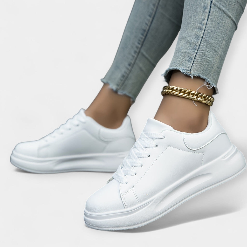 Women's classic white trainers with a clean minimal design and cushioned support sole