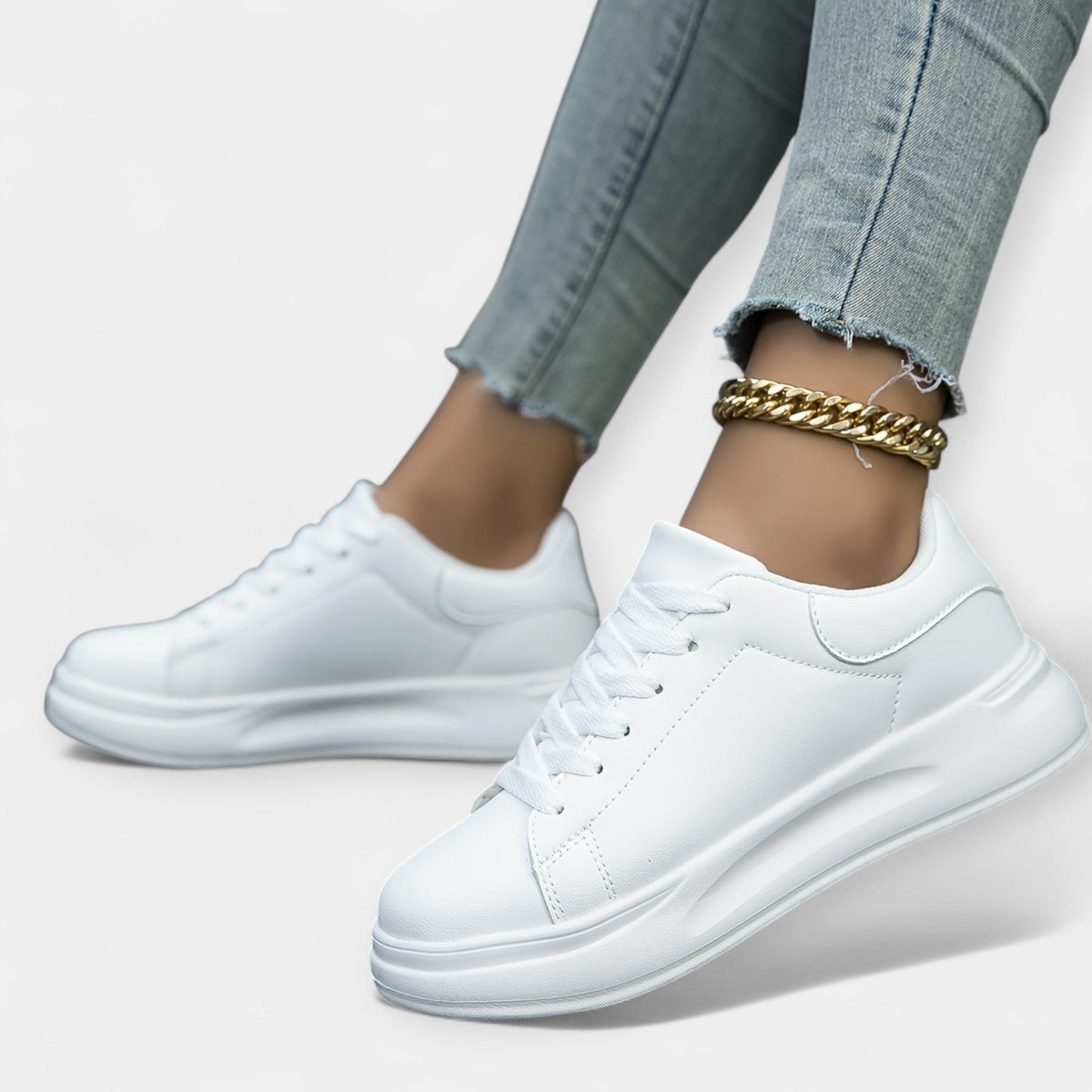Women's classic white trainers with a clean minimal design and cushioned support sole