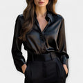 Black lustrous collar blouse with a smooth sheen finish and elegant refined neckline