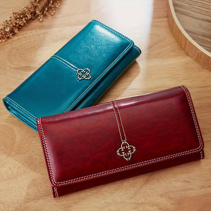 A woman holding an open bifold wallet, tucking a card into its slot.