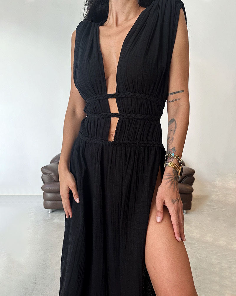Woman in a softly textured dress with front slit and cinched waist tie at golden hour.