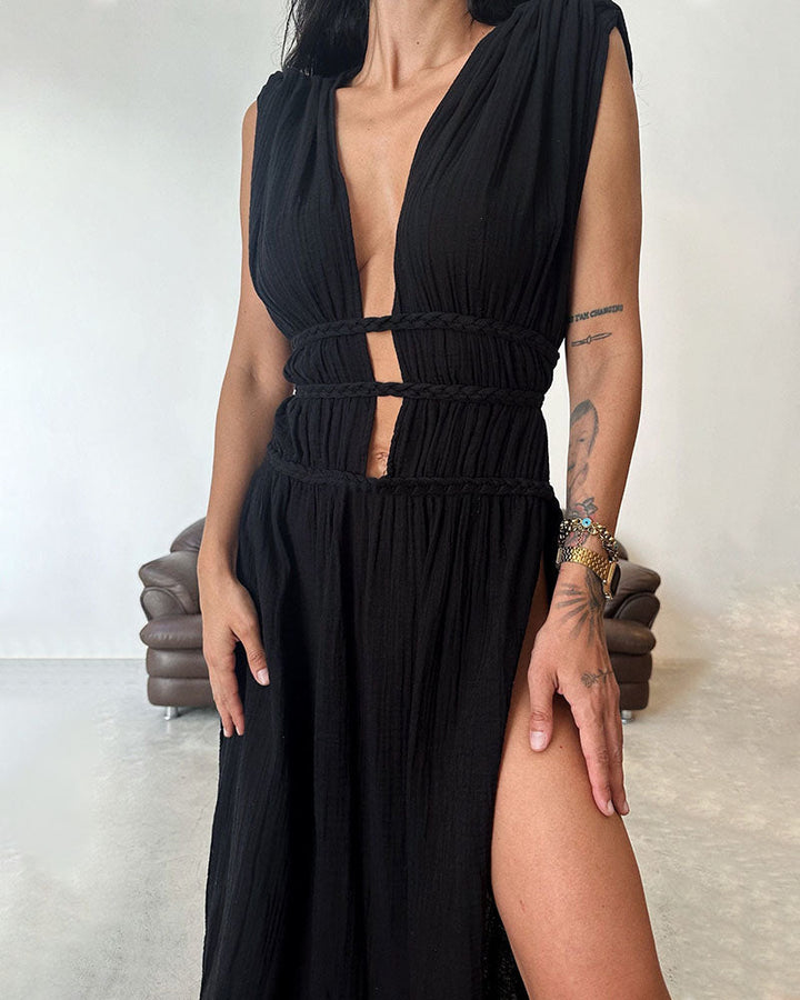 Woman in a softly textured dress with front slit and cinched waist tie at golden hour.