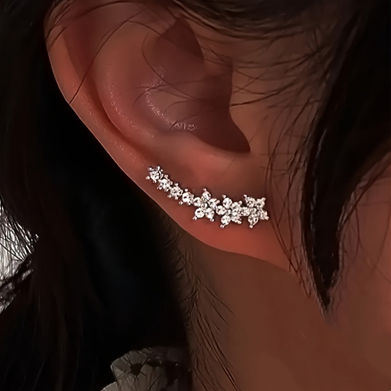 Rose gold floral crawler earrings with delicate sparkling floral motif following the curve of the ear