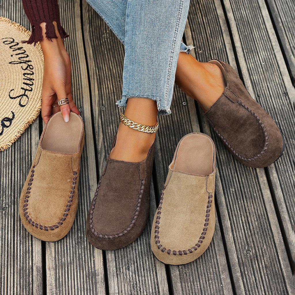 A pair of minimal slip-on loafers in warm brown with a soft footbed and open back