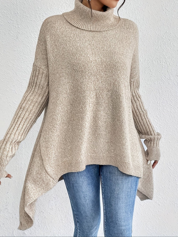 A woman wearing a stand-collar jumper with a chic asymmetric drape, warm and polished.