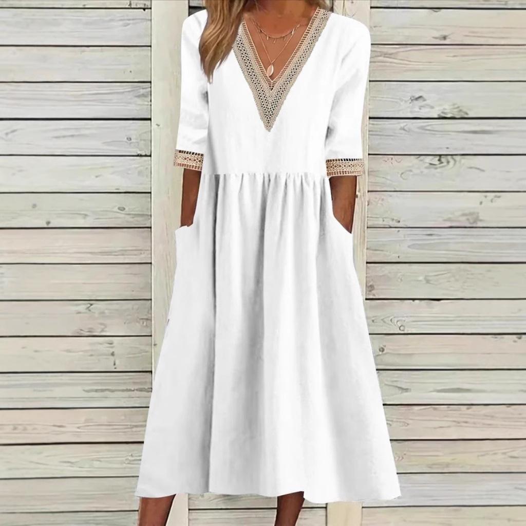A woman wearing the Deirdre V-neck midi dress with delicate detailing at the collar and sleeves.