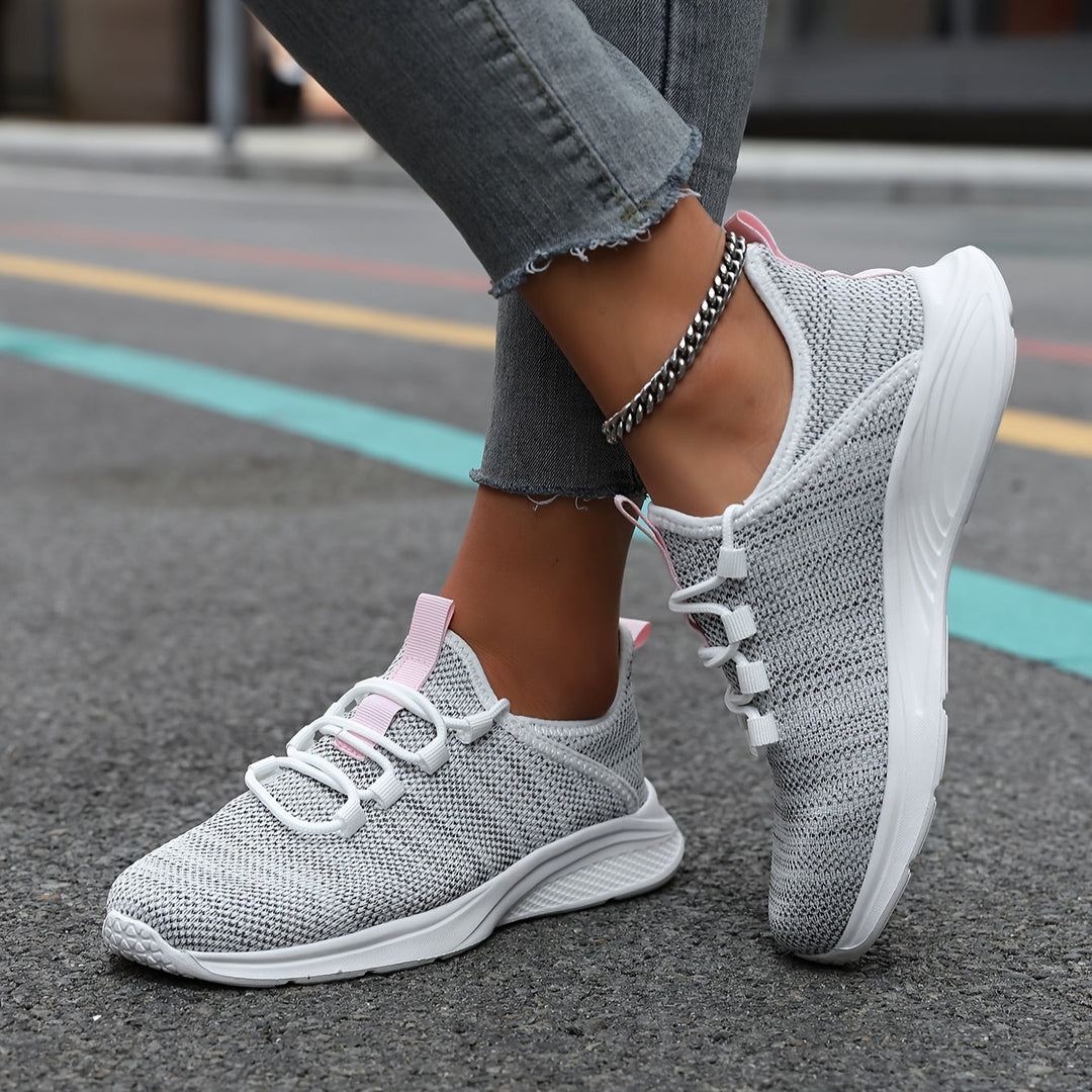 A woman walking comfortably in lightweight breathable trainers with trousers