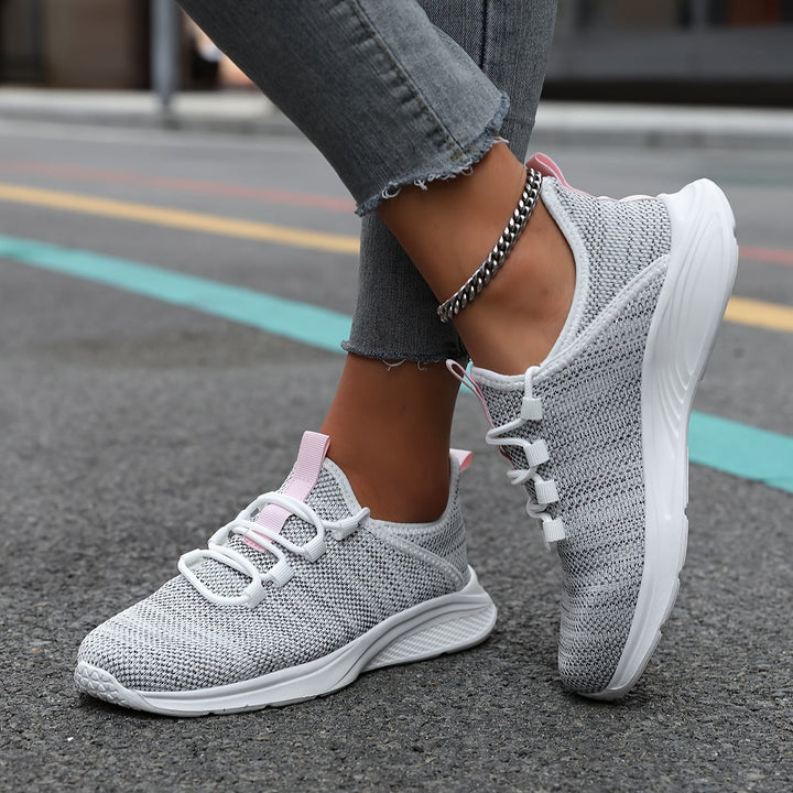 A woman walking comfortably in lightweight breathable trainers with trousers
