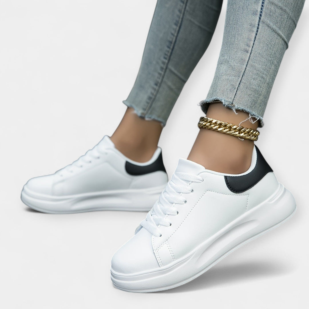 Women's classic white trainers with a clean minimal design and cushioned support sole
