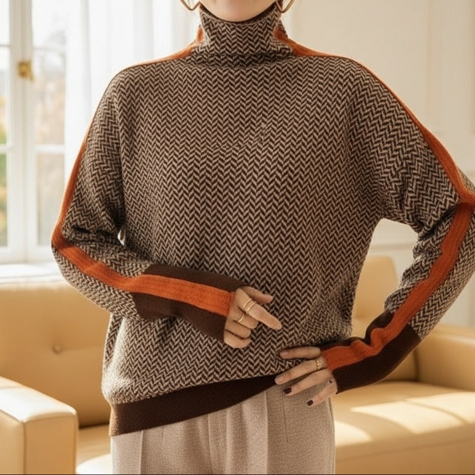 A woman wearing a brown and beige chevron high-collar jumper with bright green side stripes.