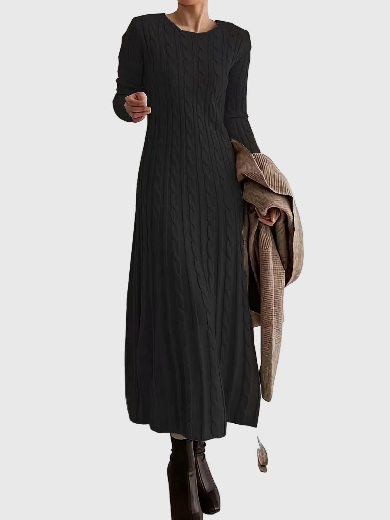 Woman wearing the Laoise cable-texture maxi dress in soft cream, styled with boots.