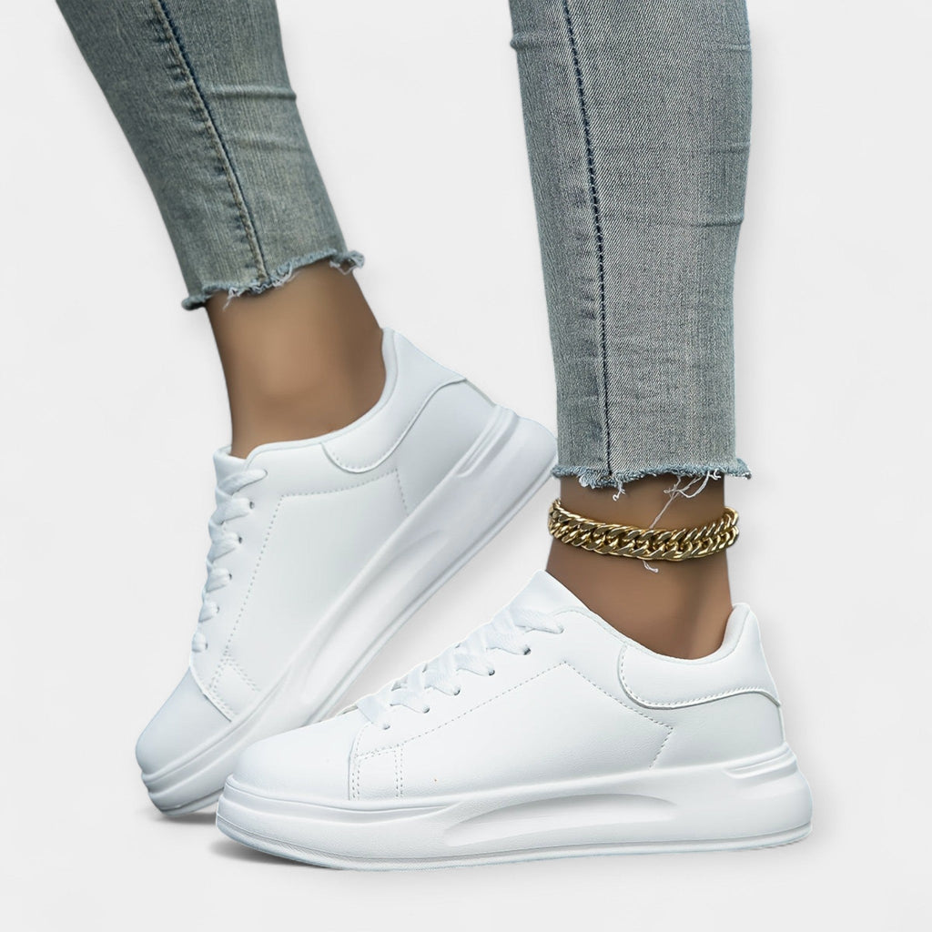 Women's classic white trainers with a clean minimal design and cushioned support sole