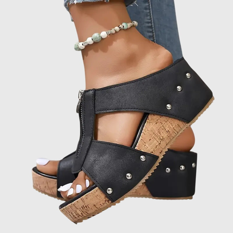 A woman standing comfortably in brown supportive sandals with an adjustable strap and cushioned sole.