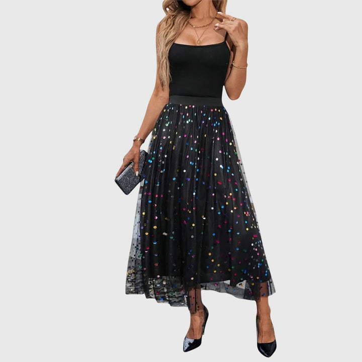 A woman in a light pleated skirt with a flowing fall, styled for an effortless everyday look.