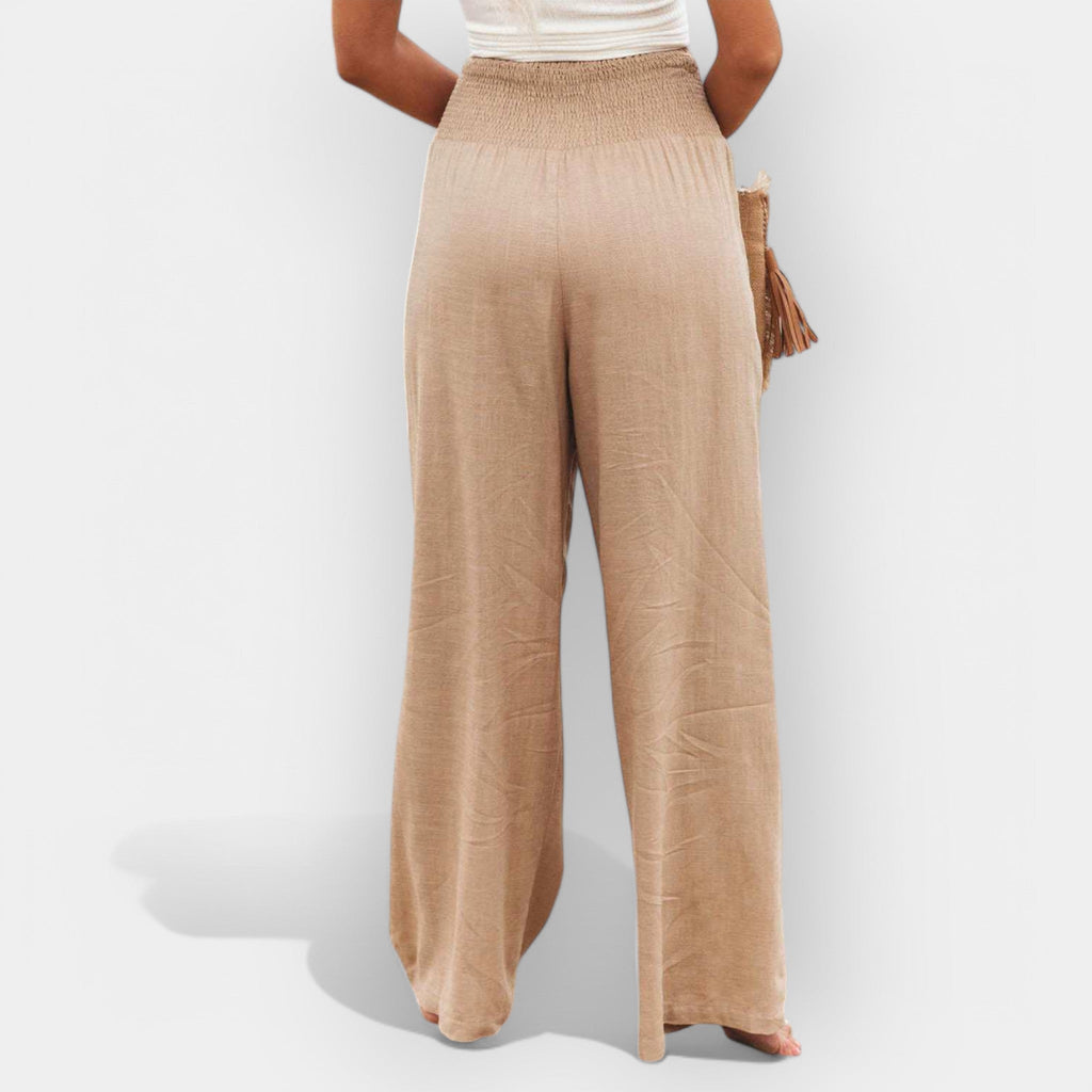 White wide-leg trousers with an elastic waist and a light, flowing silhouette