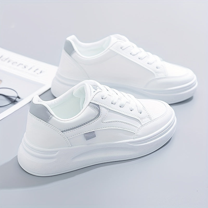 A woman in crisp white light comfort trainers paired with jeans.