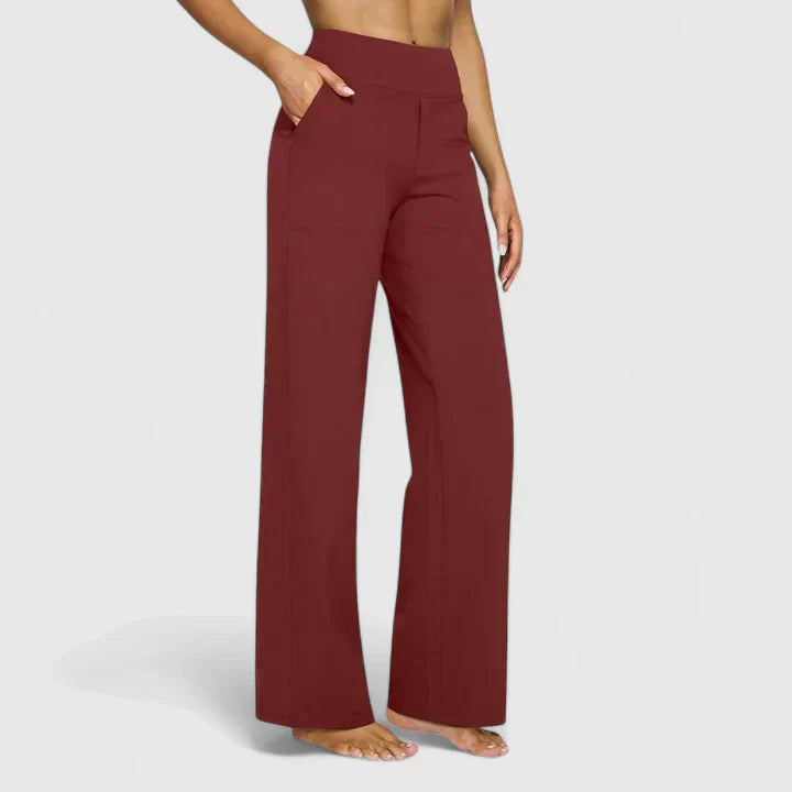 A woman in tailored trousers styled with a simple top for an elegant, comfortable everyday look.