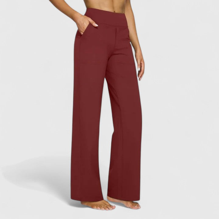 Woman wearing pull-on trousers with a soft blouse, relaxed and comfortable at home.