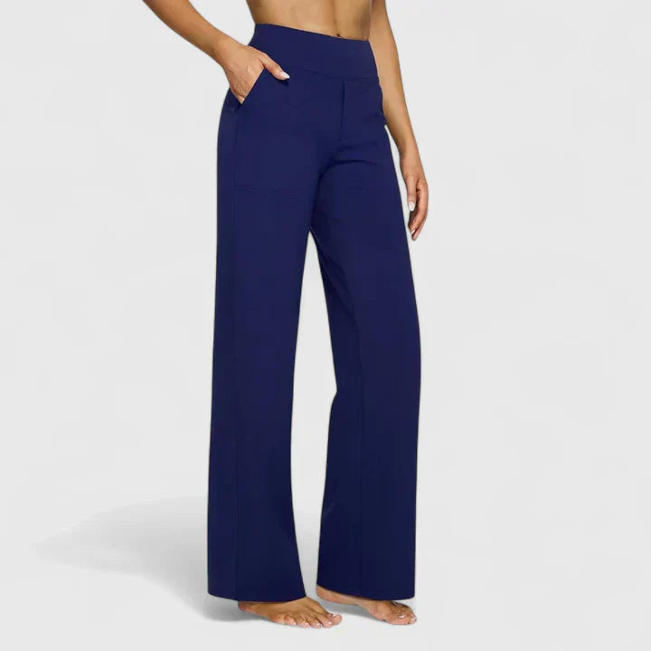 A woman in tailored trousers styled with a simple top for an elegant, comfortable everyday look.