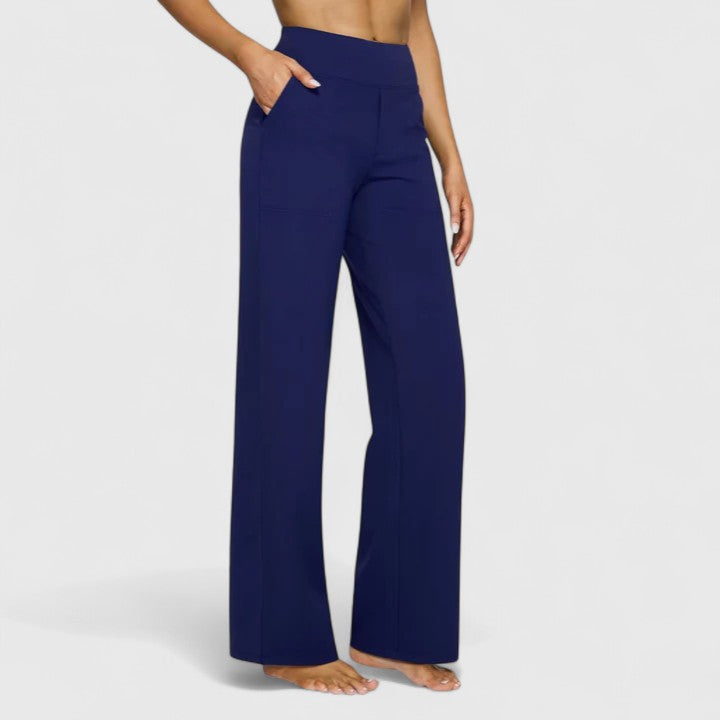 Woman wearing pull-on trousers with a soft blouse, relaxed and comfortable at home.