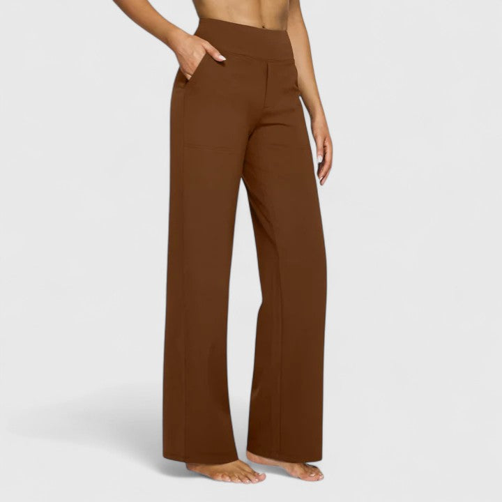 Woman wearing pull-on trousers with a soft blouse, relaxed and comfortable at home.
