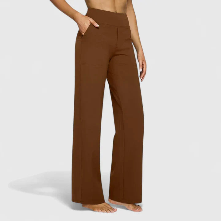 A woman in tailored trousers styled with a simple top for an elegant, comfortable everyday look.