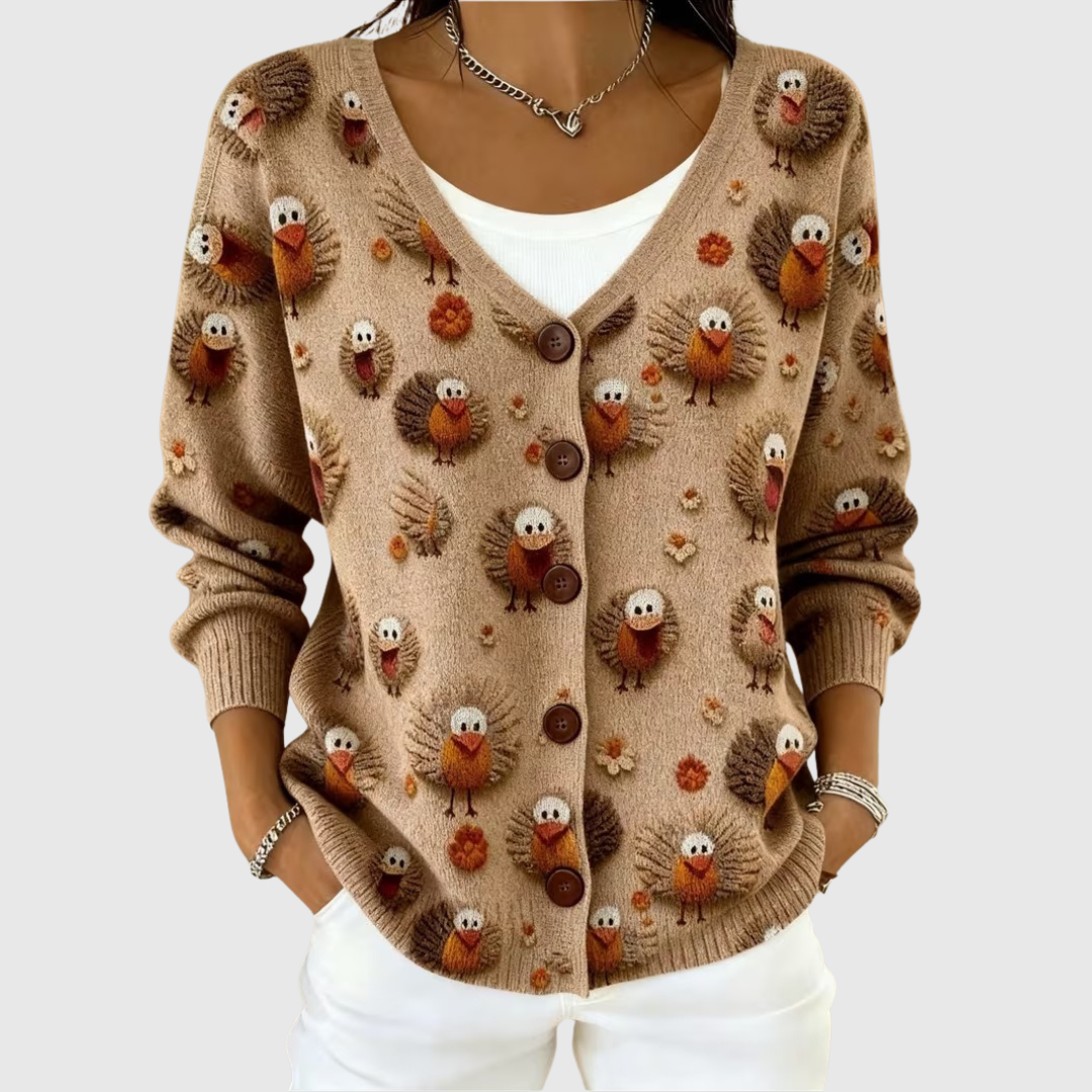 A woman in an everyday buttoned cardigan worn open over a blouse, smiling in soft daylight.