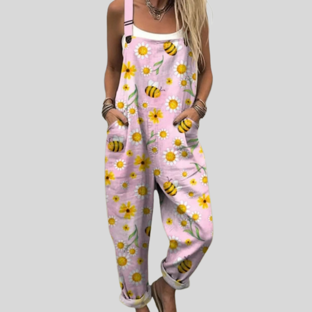 Soft pink wide-leg dungarees with a playful print of bees and yellow daisy blossoms.