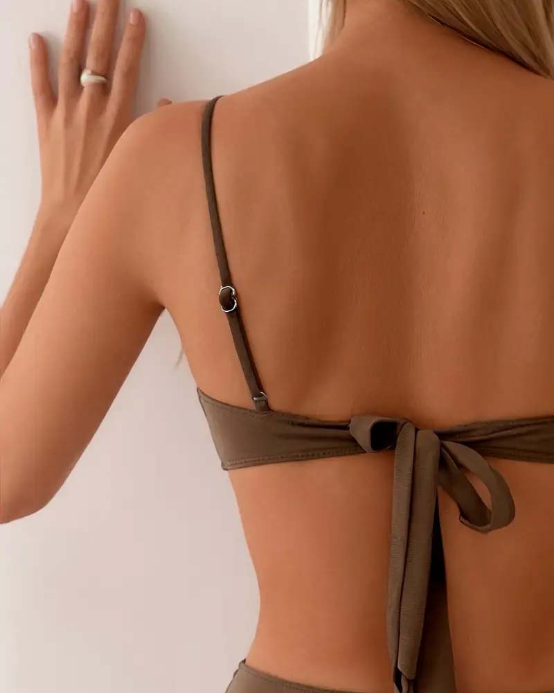 Navy blue bandeau bikini with a gold ring detail and colour-block panels