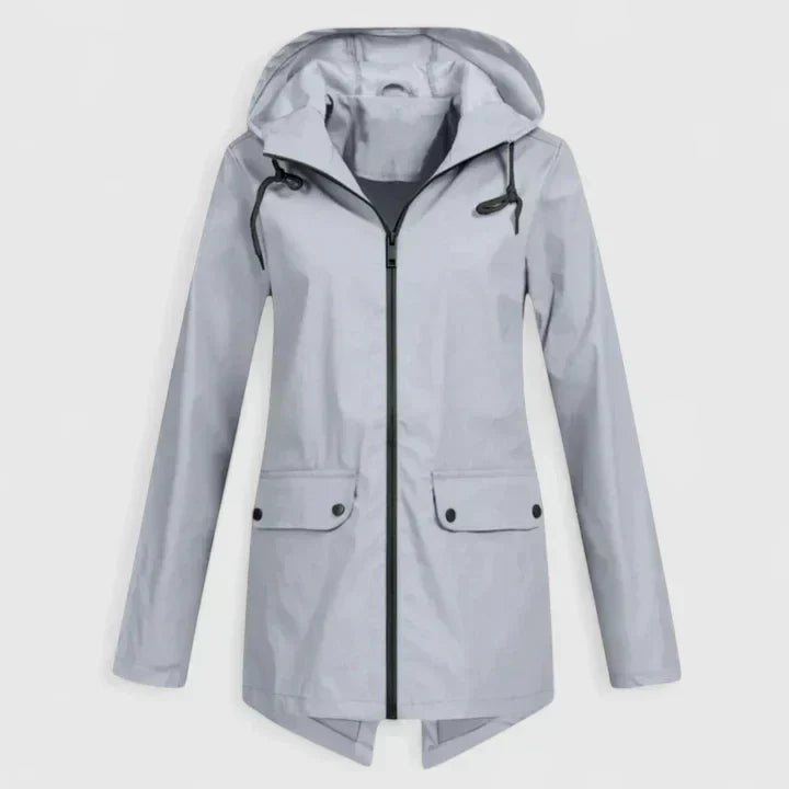 A woman wearing a hooded rain jacket, walking outdoors in light rain
