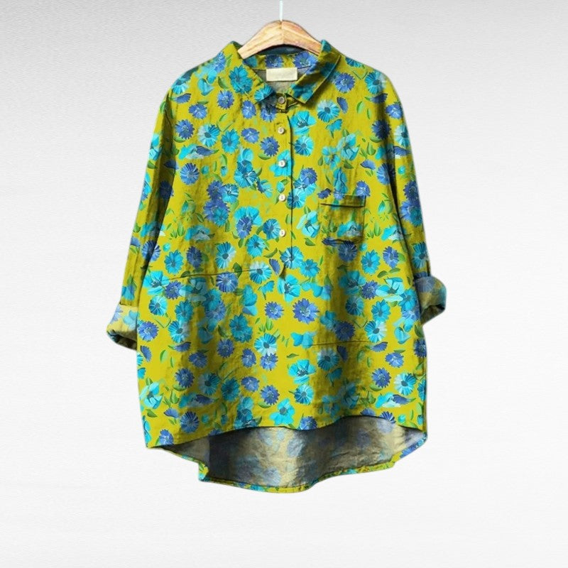 Woman wearing an airy printed summer blouse that drapes softly over the figure.