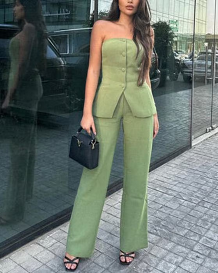 A woman wearing a tailored sleeveless button-detail top with matching wide-leg trousers.