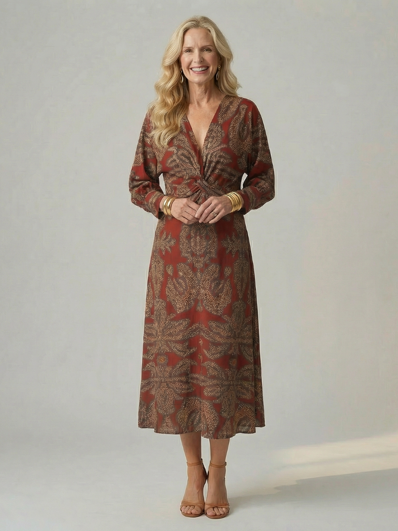 Dark green long-sleeve midi dress with diagonal wrap bodice and straight skirt in a detailed print