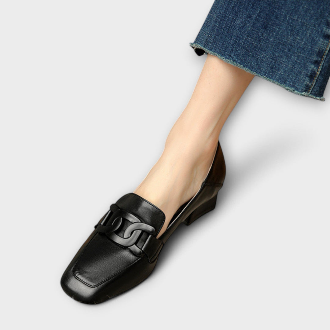 A woman in soft everyday slippers relaxing at home in the morning.