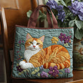 Quilted tote bag featuring a ginger orange cat in a decorative setting