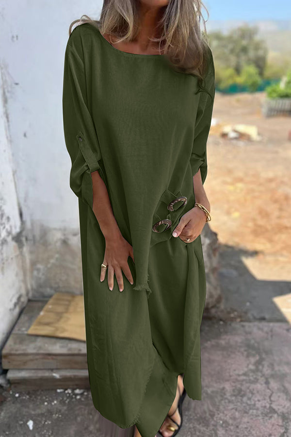 A woman wearing a flowing draped two-piece set with an asymmetric hem, relaxed and elegant.
