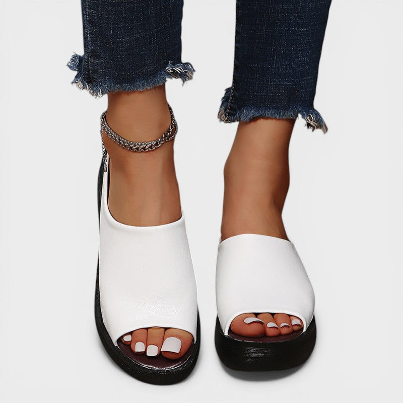 Open wedge mule sandals in white and brown with wide straps and a balanced wedge sole