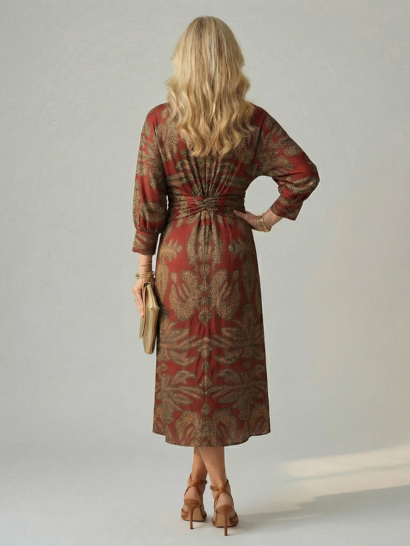 Dark green long-sleeve midi dress with diagonal wrap bodice and straight skirt in a detailed print