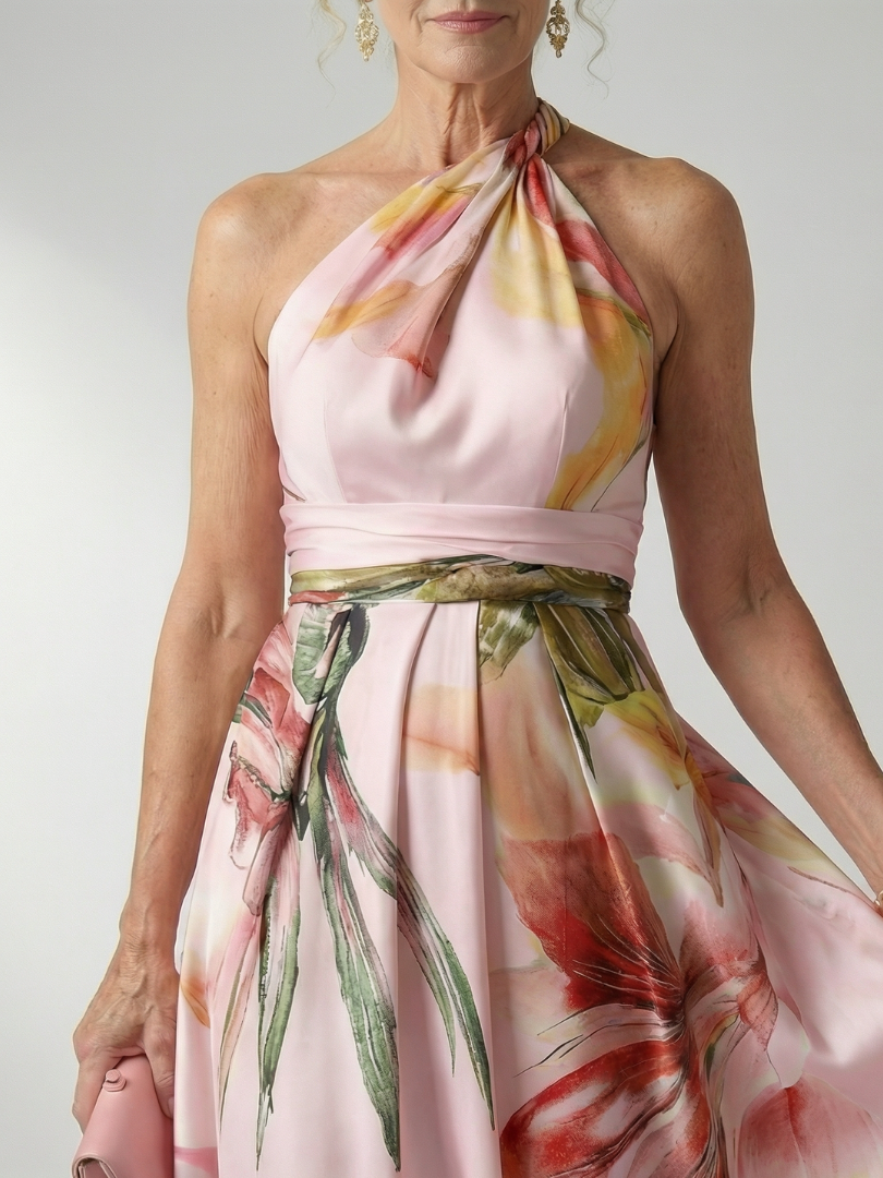 White floral halter-neck maxi dress with large bold print and flowing relaxed skirt