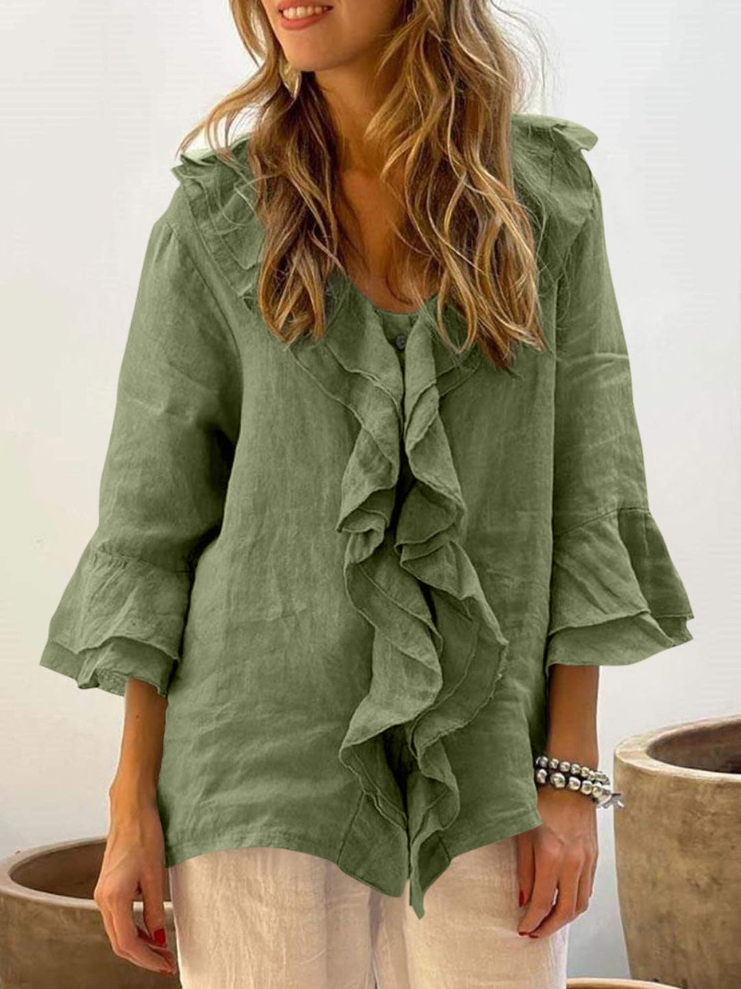 Blue floaty blouse with wide frill sleeves and a relaxed, feminine silhouette
