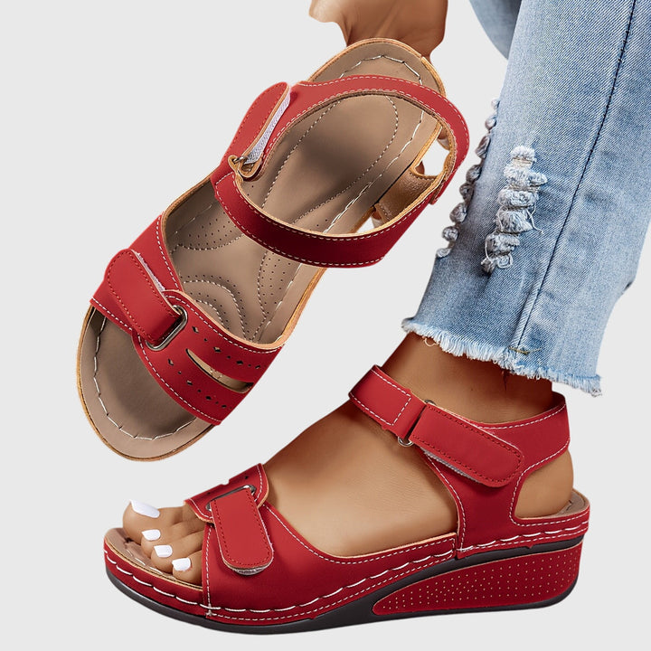 A woman wearing wide-fit supportive sandals with a relaxed summer outfit, walking with ease and confidence.