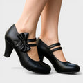 Women's mid-height heels in black with a soft delicate bow at the toe