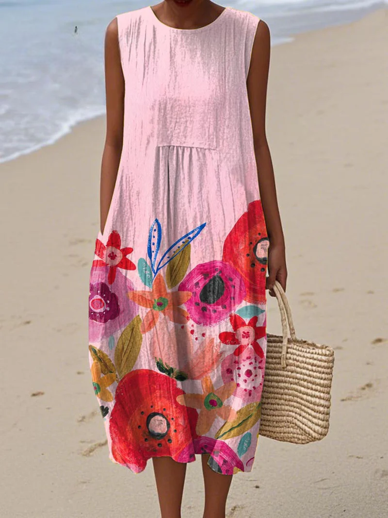 A soft blush pink sleeveless dress with large vibrant flowers in red, coral and lavender