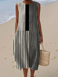A sleeveless black and white monochrome vertical stripe dress with a fluid and flattering silhouette