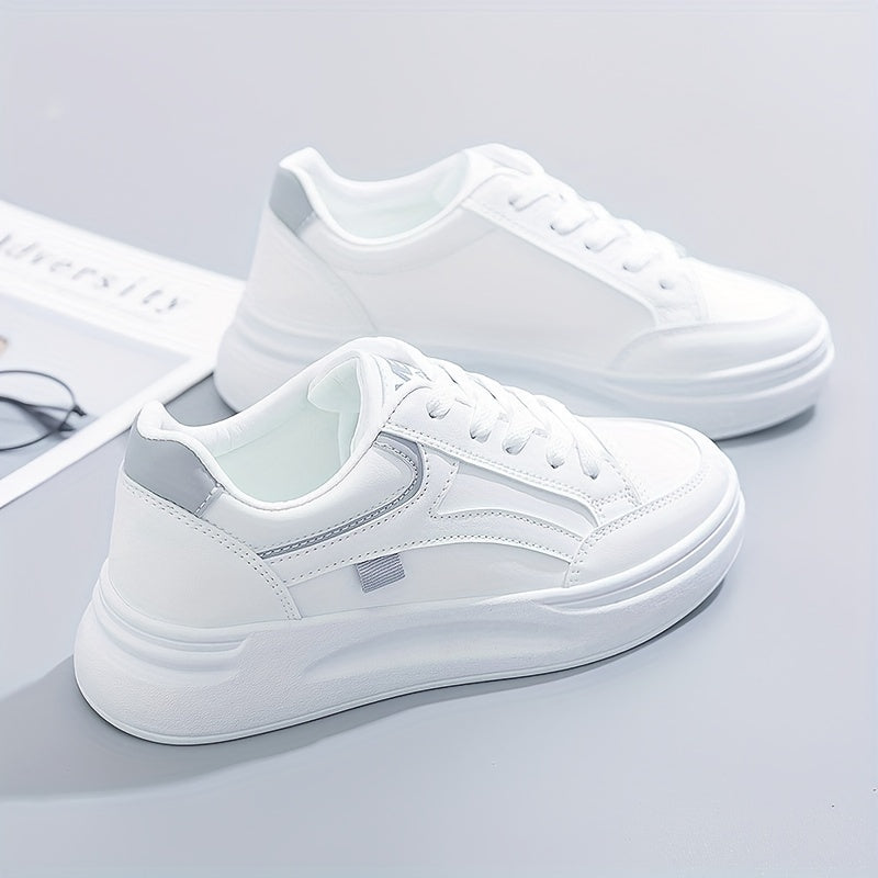 A woman in crisp white light comfort trainers paired with jeans.