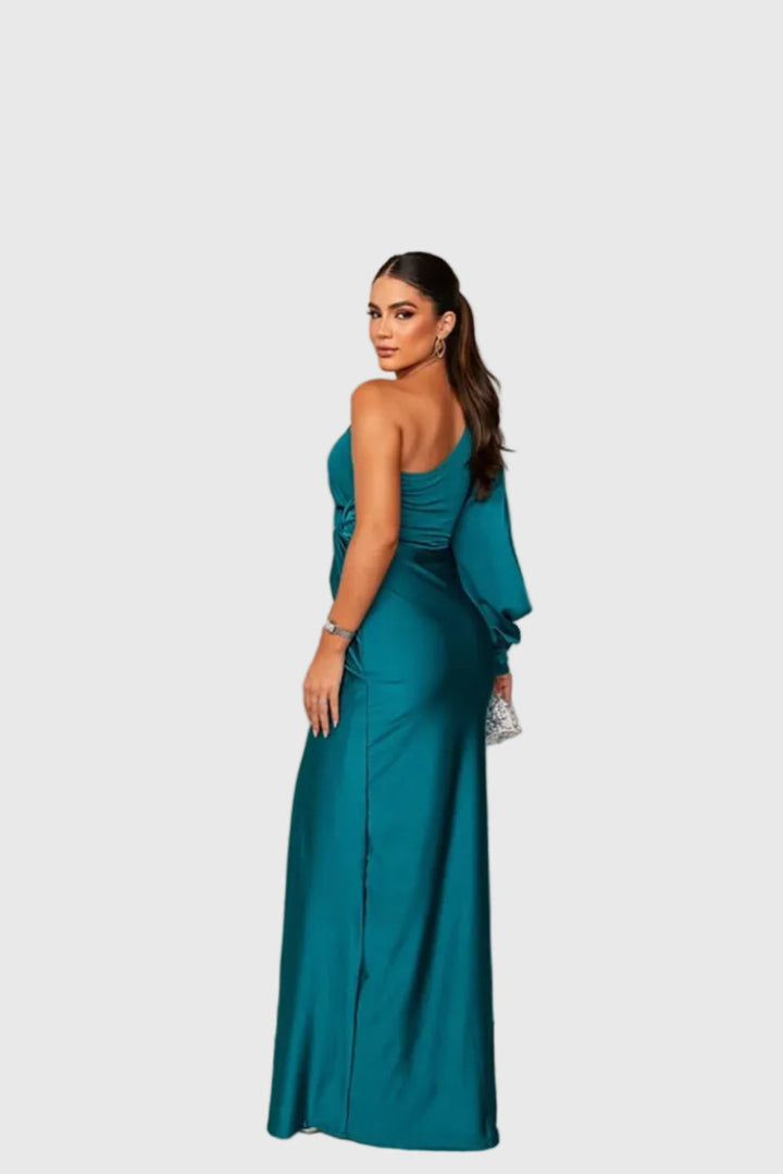 Woman wearing a long flowing evening maxi dress with elegant, graceful lines.