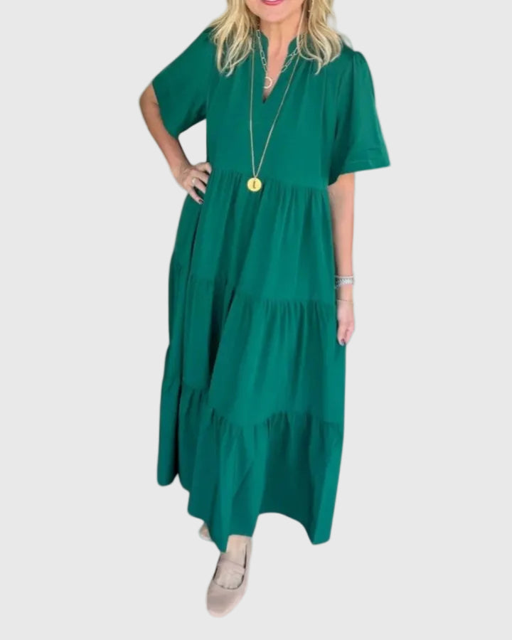 Woman wearing the Kate maxi dress with her hands resting in its side pockets.