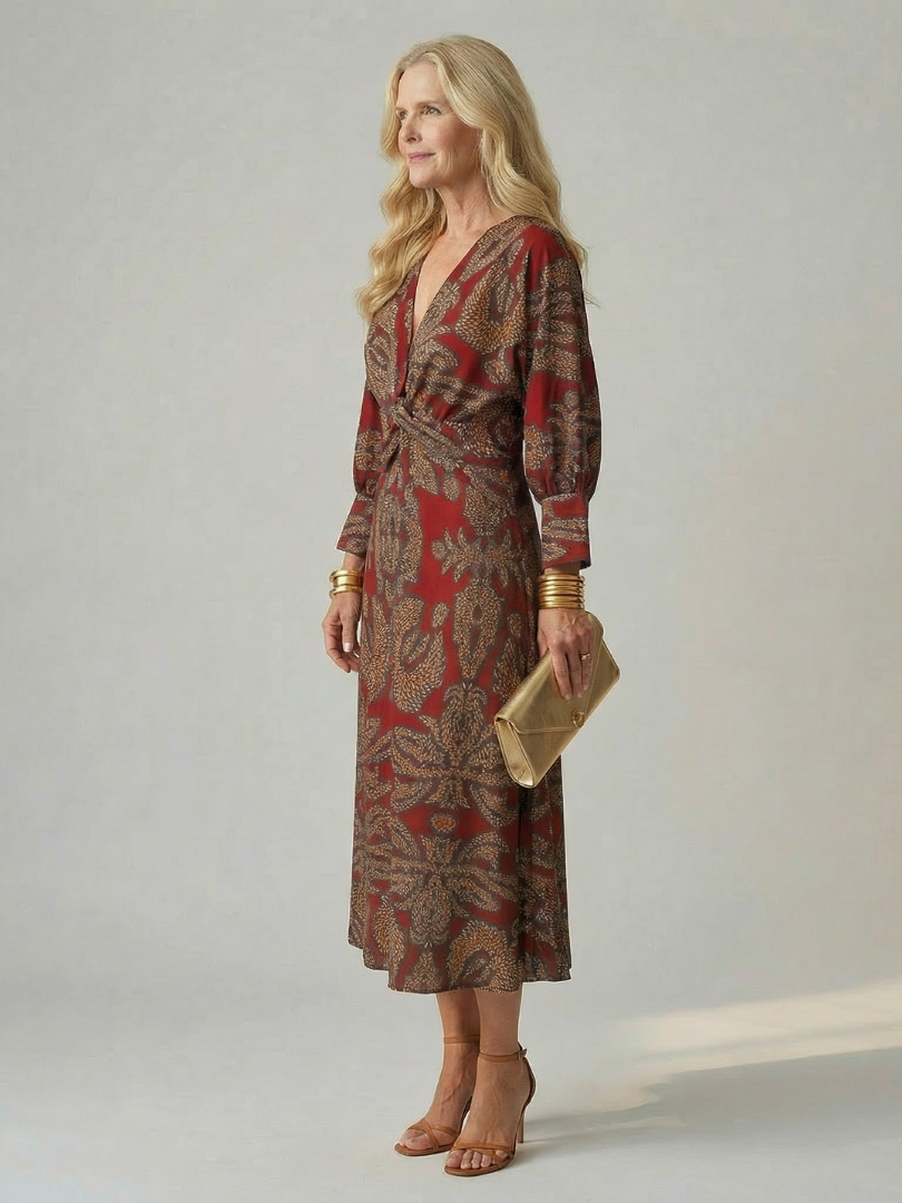 Dark green long-sleeve midi dress with diagonal wrap bodice and straight skirt in a detailed print